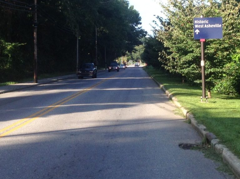 street with sign that says historic west asheville