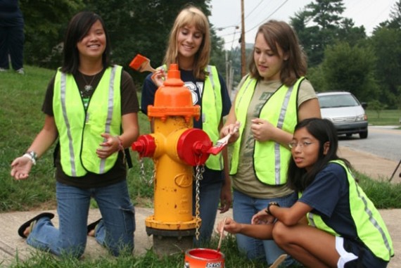 girl scouts painting fire hydrant