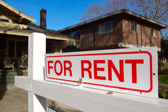 "for rent" sign in front of rental house