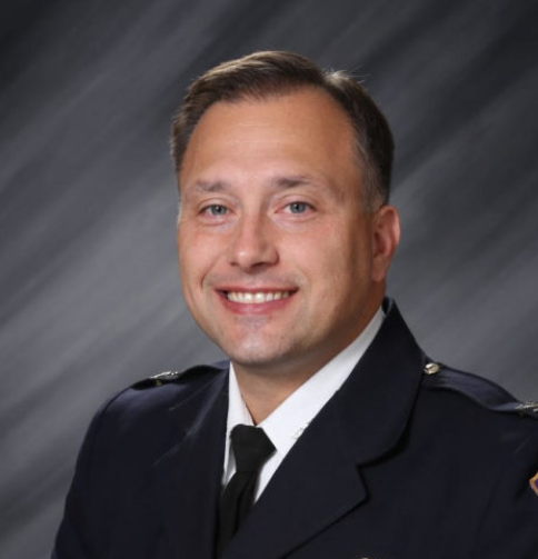 Photograph (headshot) of Chief Bailey with simple grey background.