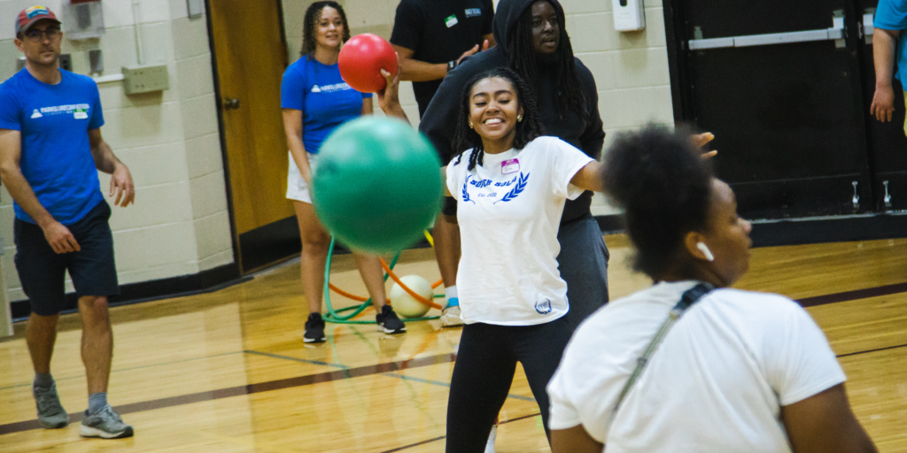 Young adults playing dodgeball