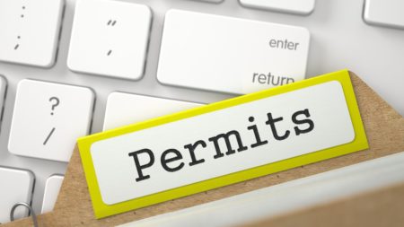 permits folder resting on computer keyboard