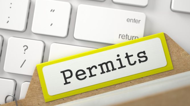 permits folder resting on computer keyboard