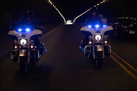 two police motorcycles driving in tunnel