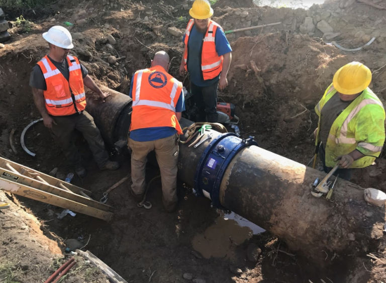 Image of an Asheville Water Maintenance crew working to repair a broken waterline on Bee Tree Creek.