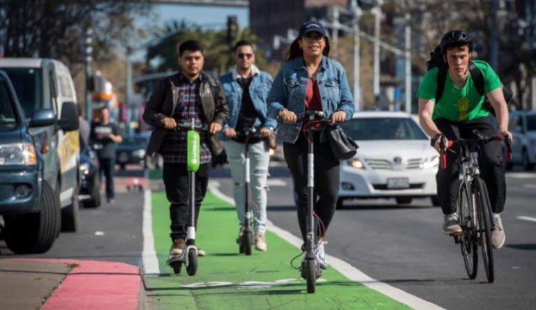 people riding scooters