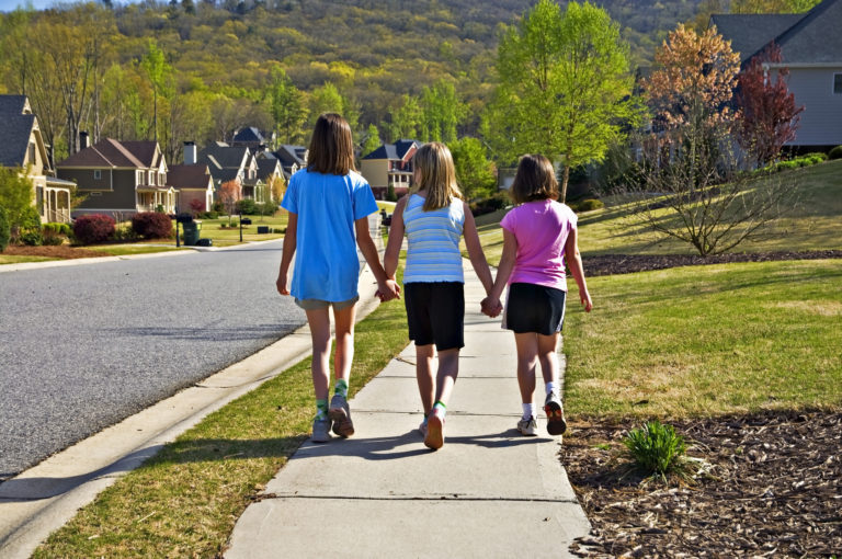 Children walking on a sidewalk