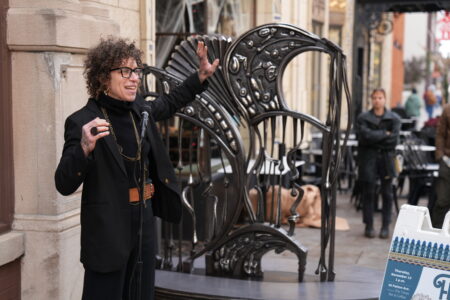 Artist Rachel David at the installation ceremony in front of Fluvial sculpture.
