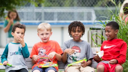 four boys sitting on a bench