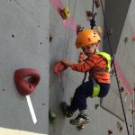 Lil boy on rock wall