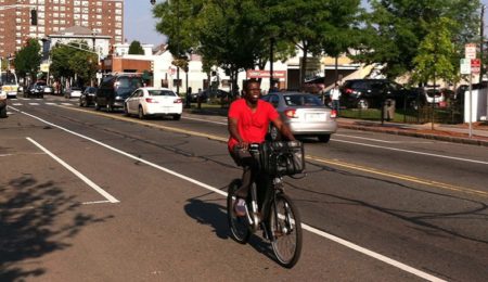 bicyclist riding down city street