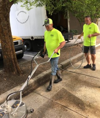 Workers cleaning downtown sidewalk