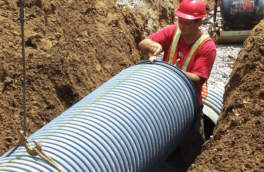 Photo of large pipe being installed in ditch
