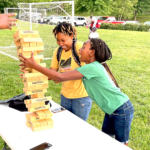 Teenagers playing Jenga at Block Party