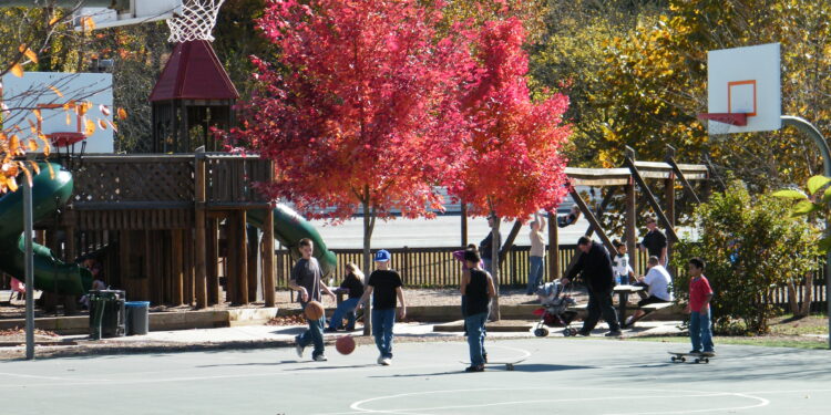 children playing on basketball court in fall