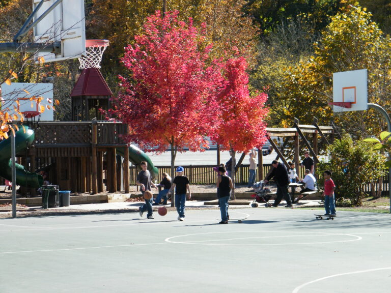 children playing on basketball court in fall