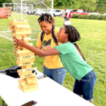 two teenagers playing large jenga