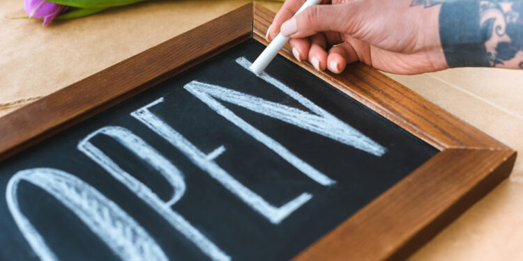 open written on chalkboard sign