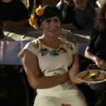 adult woman with plate of tamales