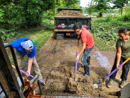 young adults working on trail with shovels