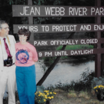 jean webb in front of sign bearing her name