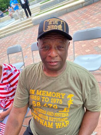 man in green in memory of shirt