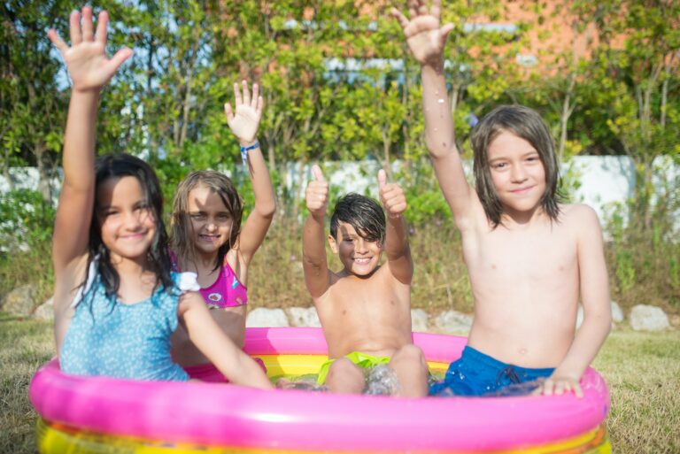 two girls two boys in inflatable pool