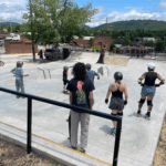 people with skates, bikes, and skateboards at asheville skatepark