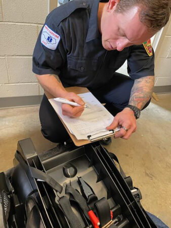 firefighter going over checklist for car seat