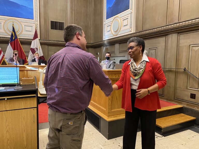 Jakob Klodt shakes hands with Debra Campbell