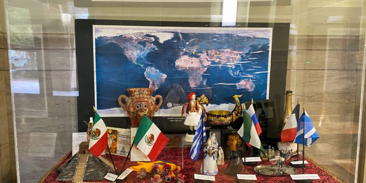 dispaly case in city hall filled with items from sister cities