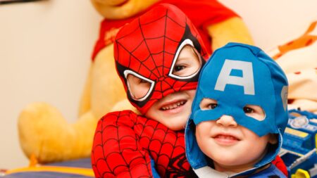 two little boys in superhero costumes hugging