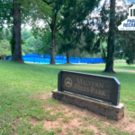 Malvern Hills Park entrance sign with park in background