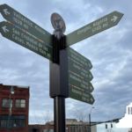 directional sign with asheville's sister cities listed with distance from park
