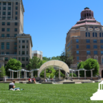 courthouse, city hall, and stage in park with lawn in the foreground