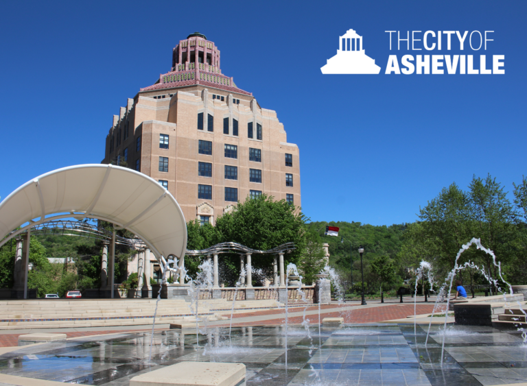city hall with splash pad in front on sunny day