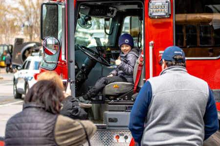 young boy in drivers seat of fire truck