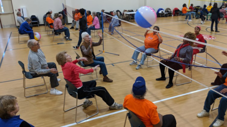 senior citizens playing chair volleyball