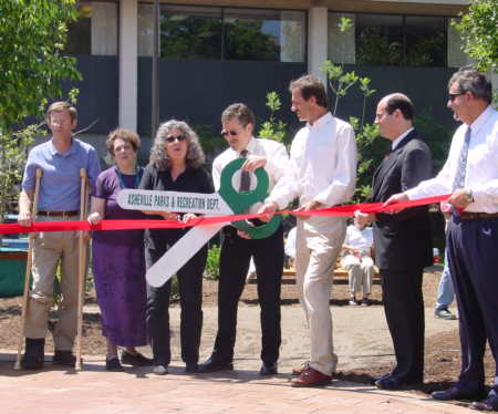 city staff cutting ribbon at renovated pritchard park