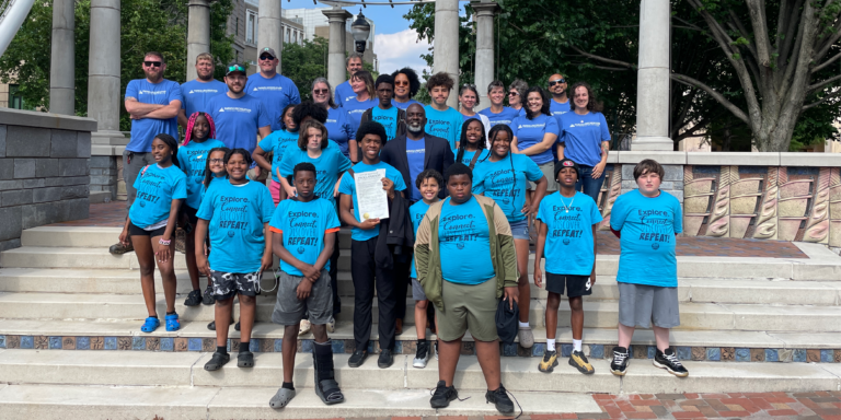 children from after school program on pack square park stage