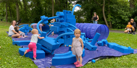 toddlers playing and climbing on blue foam