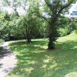 paved greenway and open lawn