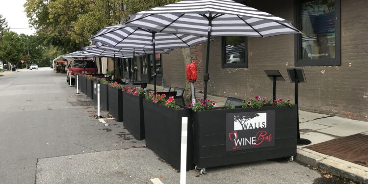 black and white umbrellas over mobile streetery units