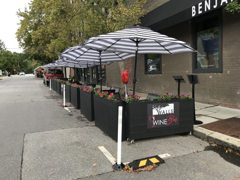 black and white umbrellas over mobile streetery units