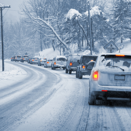 snowy road with line of cars