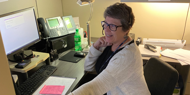 nora jones sitting at her desk in parks and recreation department