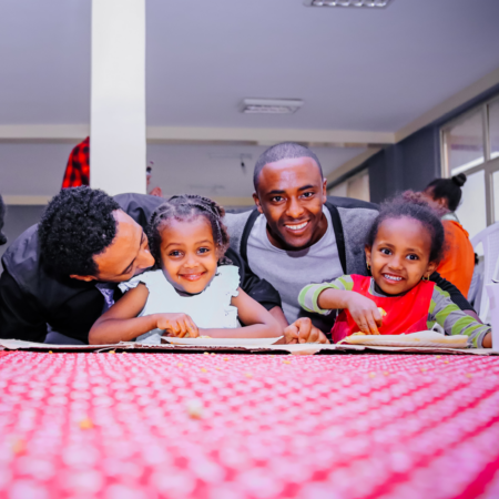 two young african american children playing board game