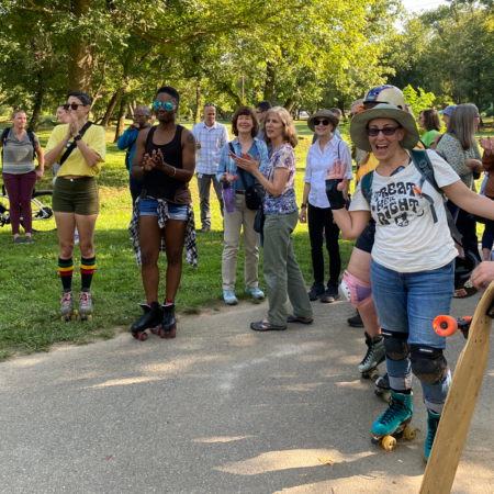 group of roller skaters, walkers on greenway trail