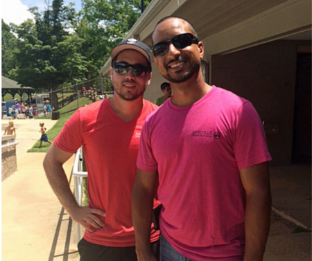 max and Seth in pink and red shirts standing on the baseball field