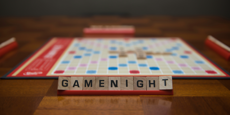 scrabble board with tiles that spell gamenight